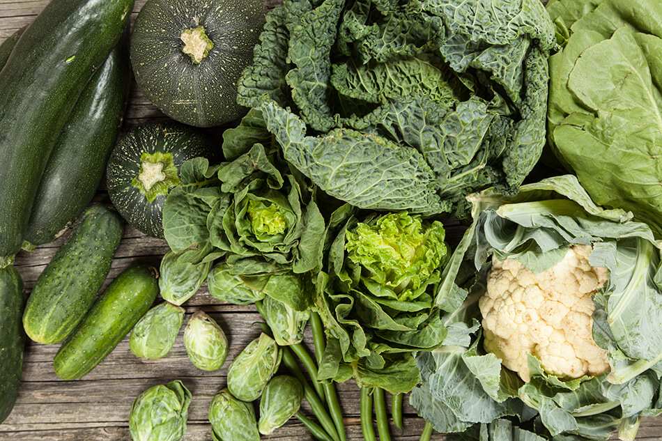 array of green vegetables on wooden table