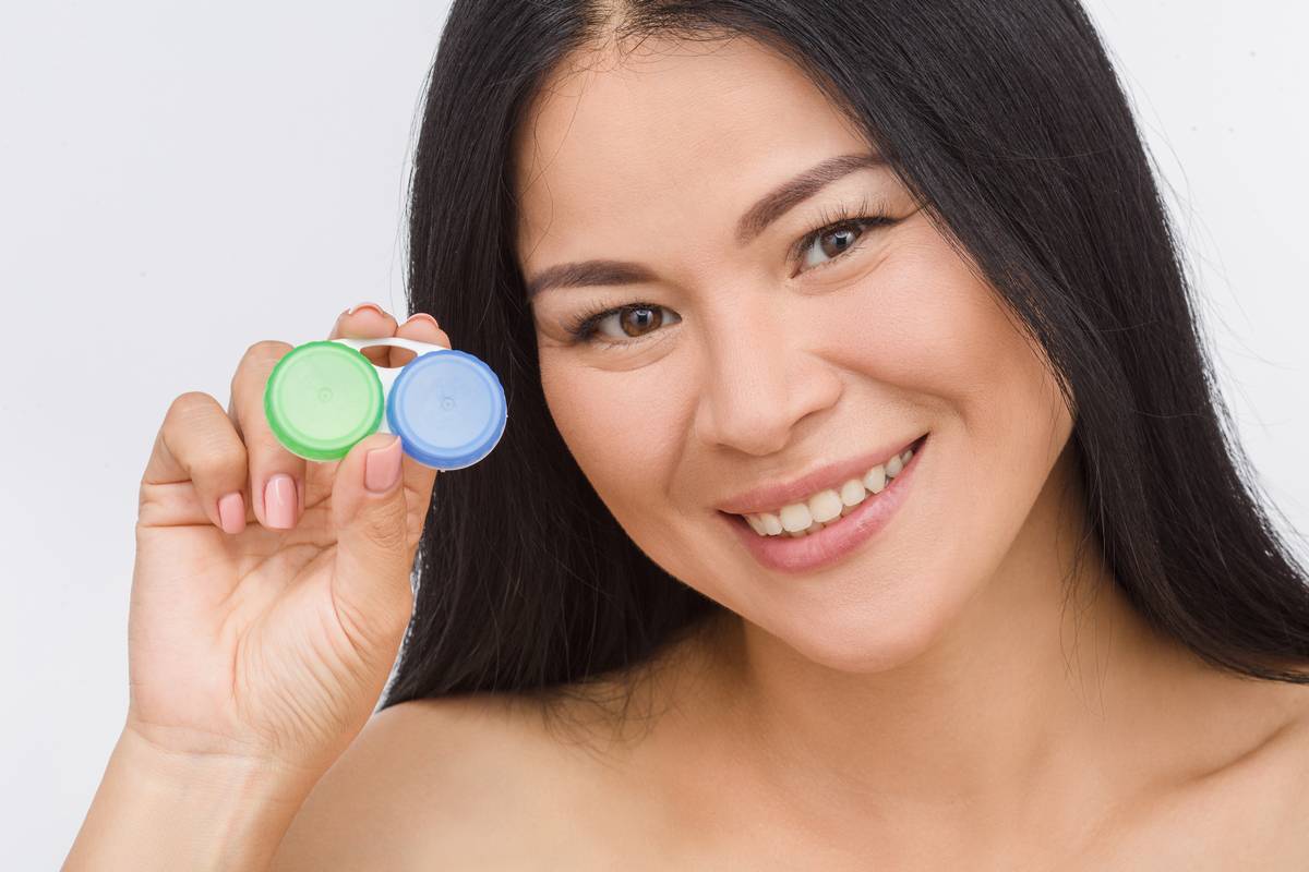 Asian woman holding contact lens case