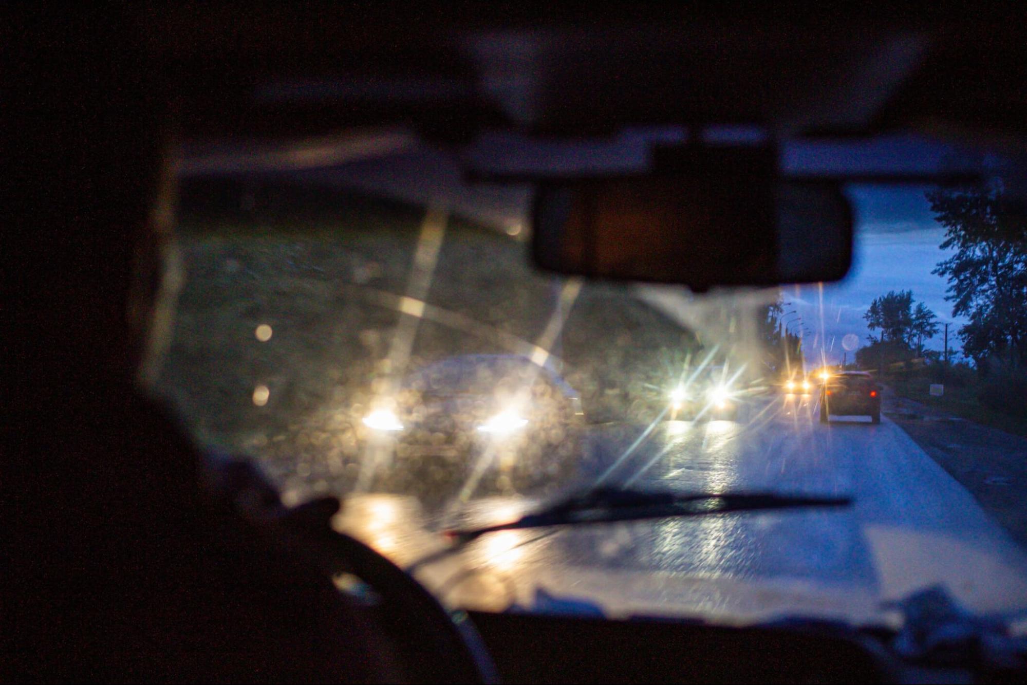 Driver's view of streaking headlights and glare at night showing how astigmatism lights look while driving