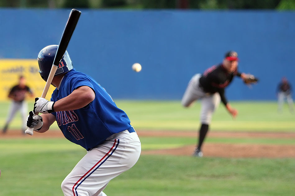 batter about to hit baseball in mid-air