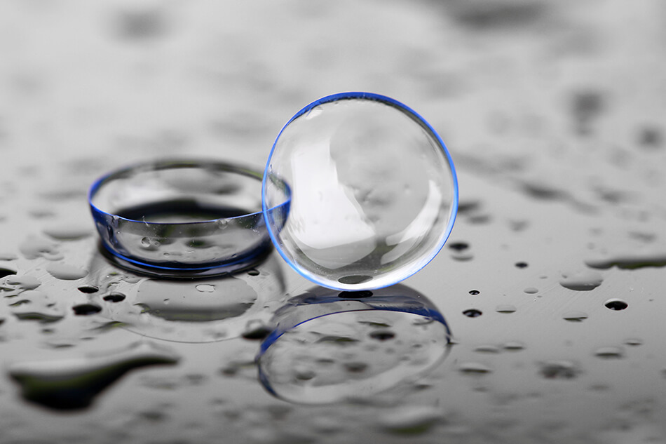 bent new contacts on the floor with water droplets