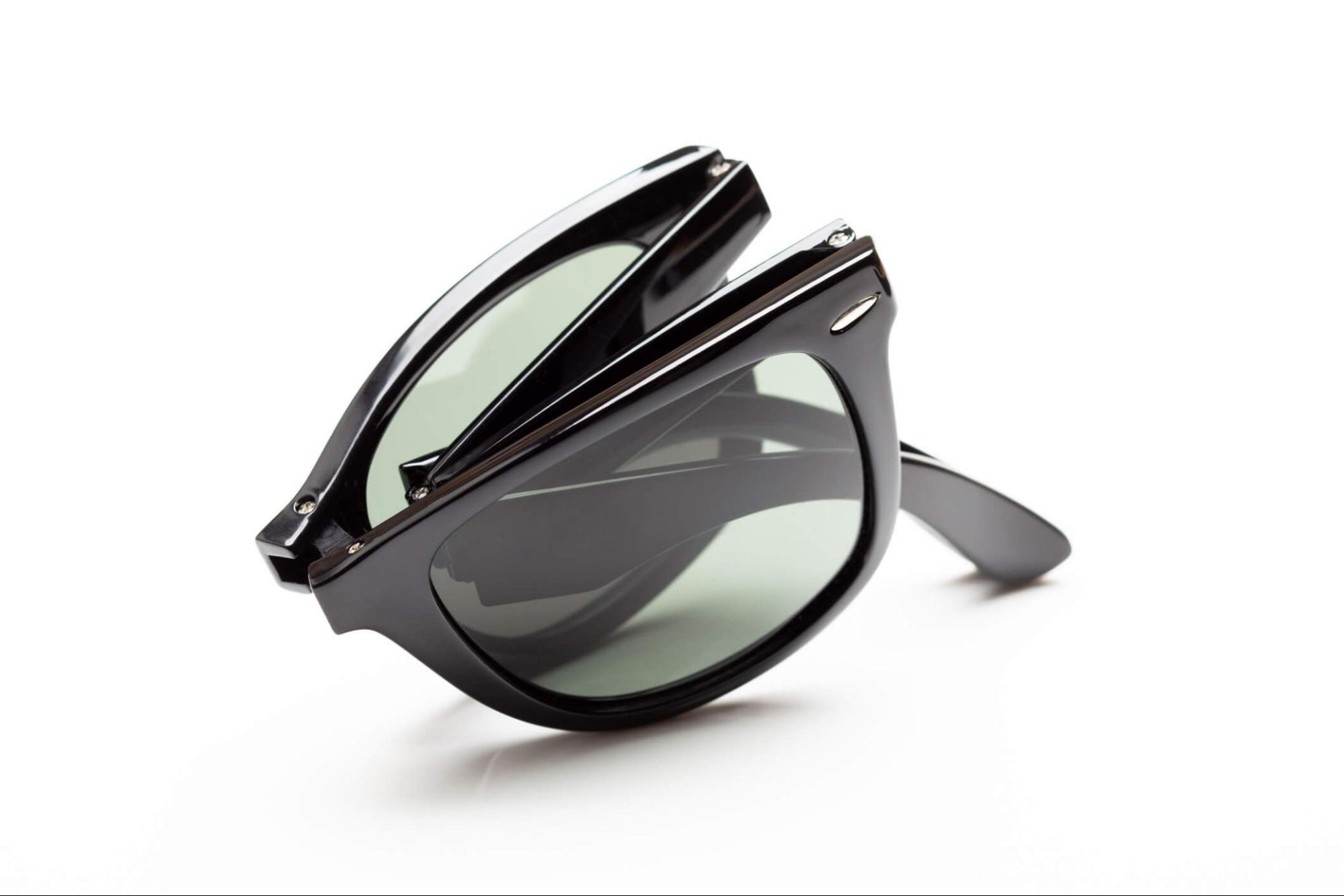 Black foldable sunglasses shown in a compact collapsed position
