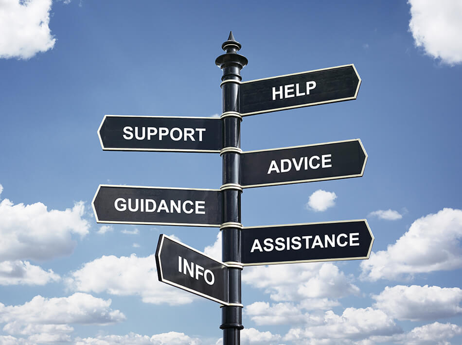 black signpost with various words on, sky and clouds background