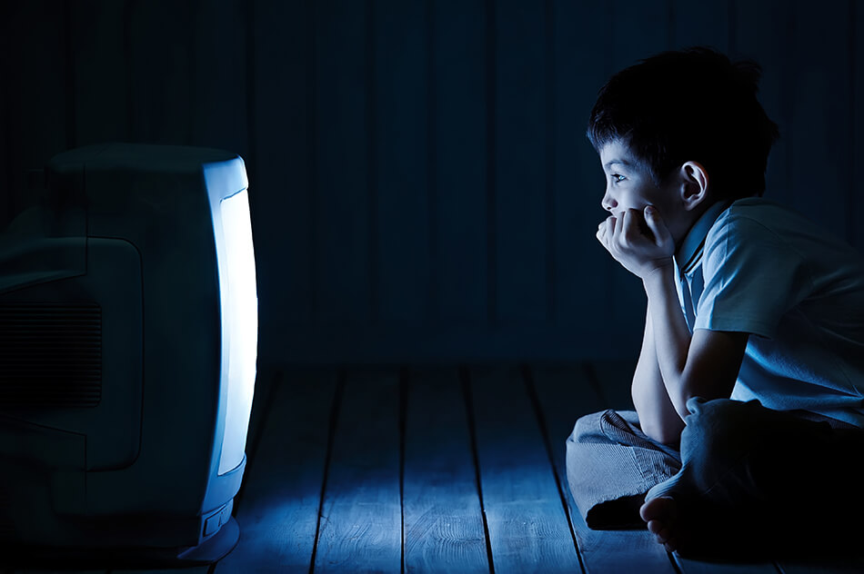 A child sitting too close to the TV