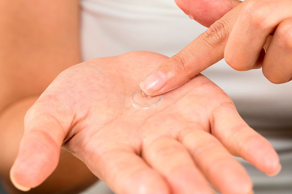 cleaning a contact lens in palm of hand