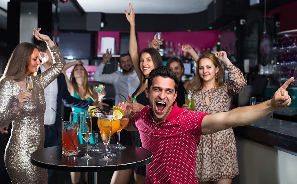 smiling college students dancing at a party