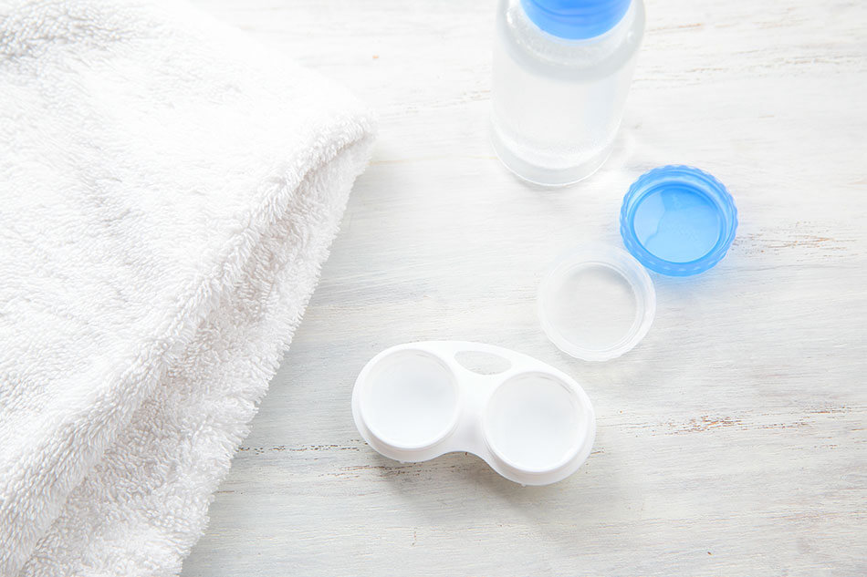 Contact lens case with solution bottle and towel