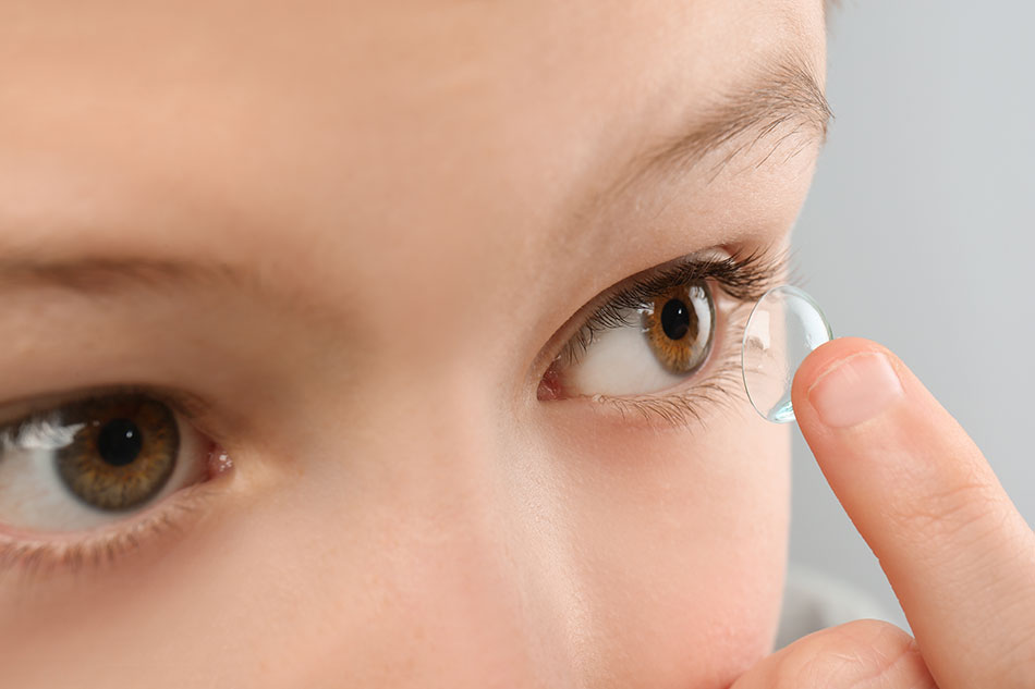 child putting in contact lenses