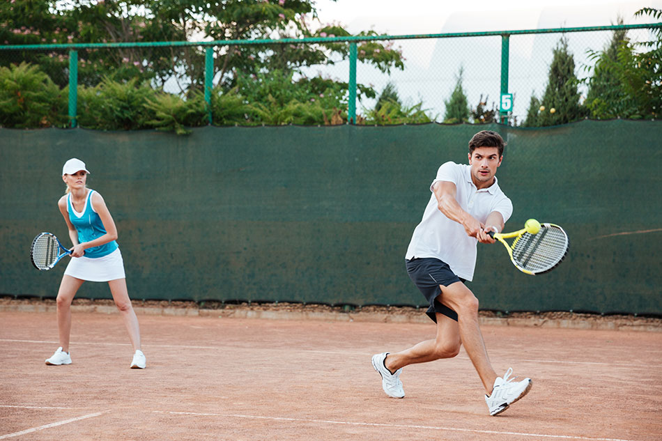 Couple playing tennis