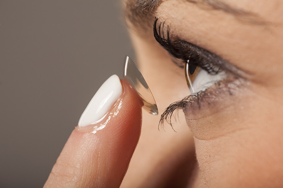 Woman putting in daily disposable contacts