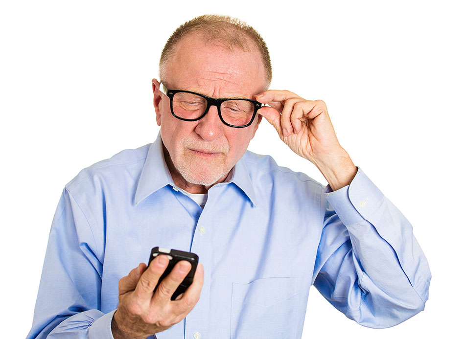 Elderly man with glasses squinting at phone