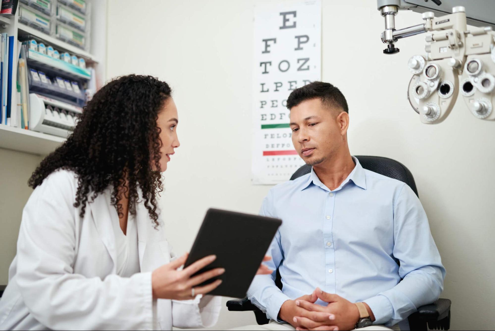 Eye doctor reviewing contact lens care instructions with a patient during an annual eye exam