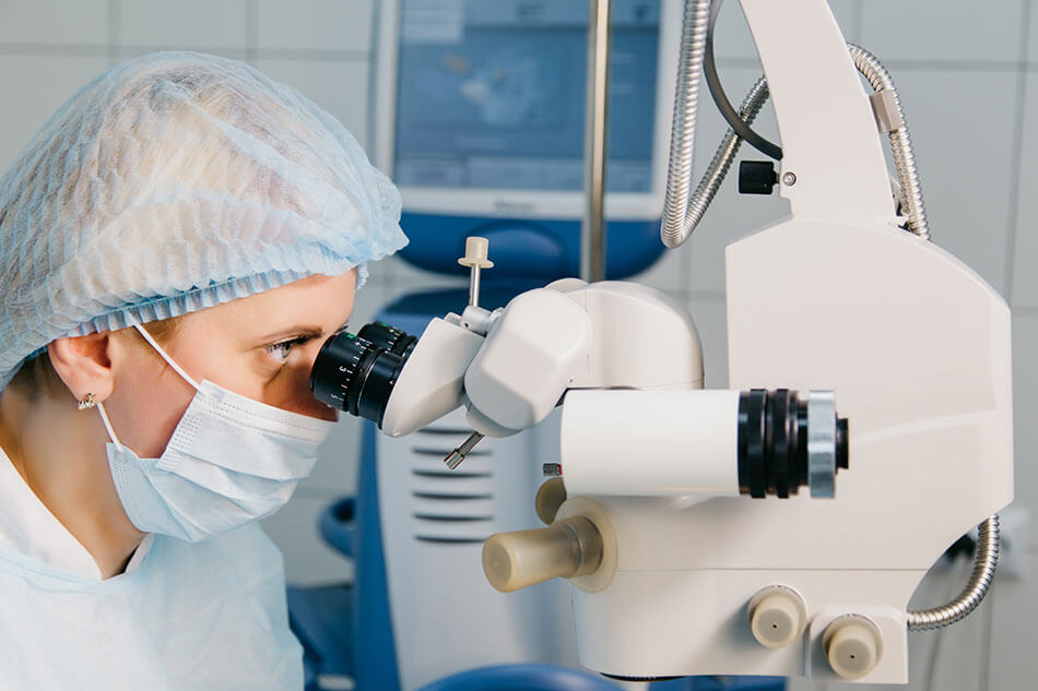 eye doctor with mask on using surgical equipment