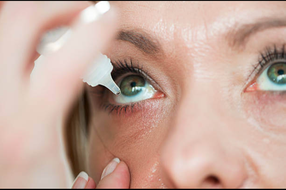 Close-up of a person applying eye drops for dry eye relief