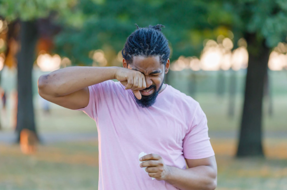 man rubbing eye irritation after using contact lenses