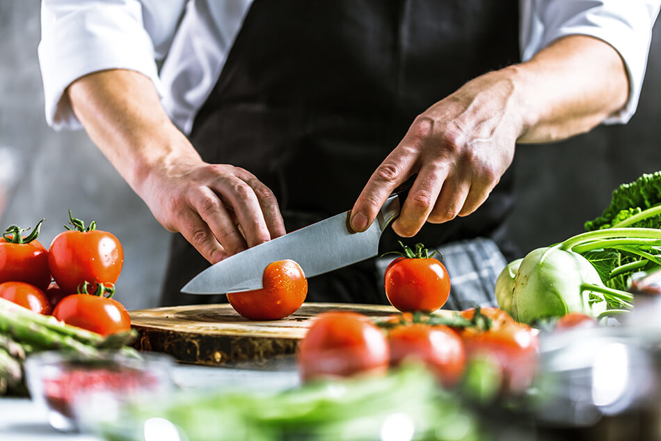 man using sharp knife on cutting board