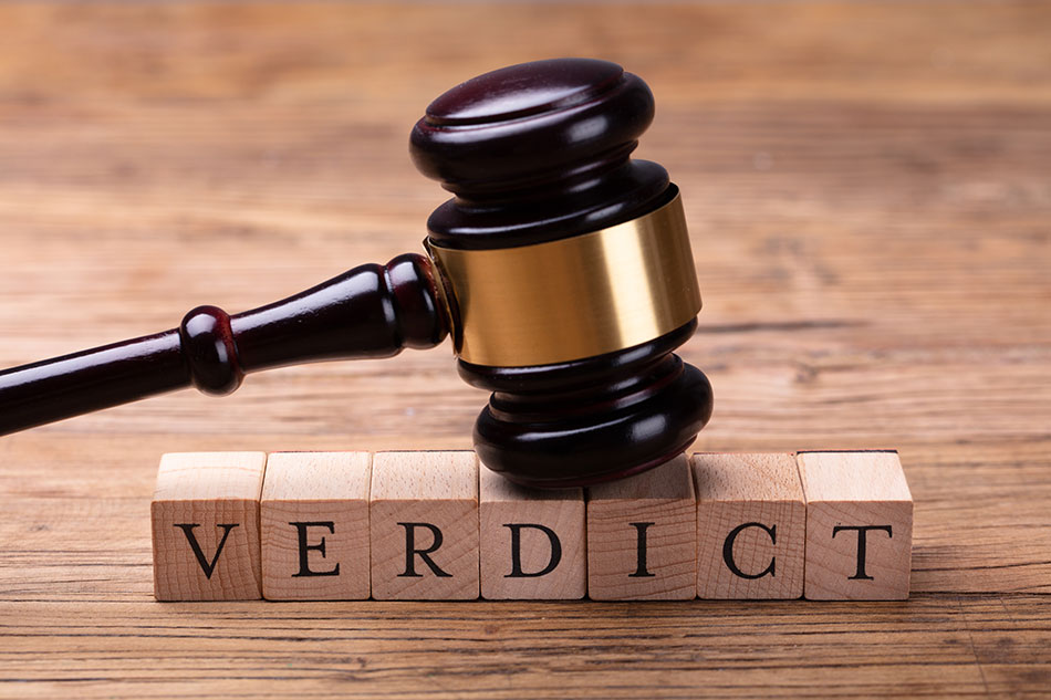 gavel on “verdict” spelled out in wooden blocks