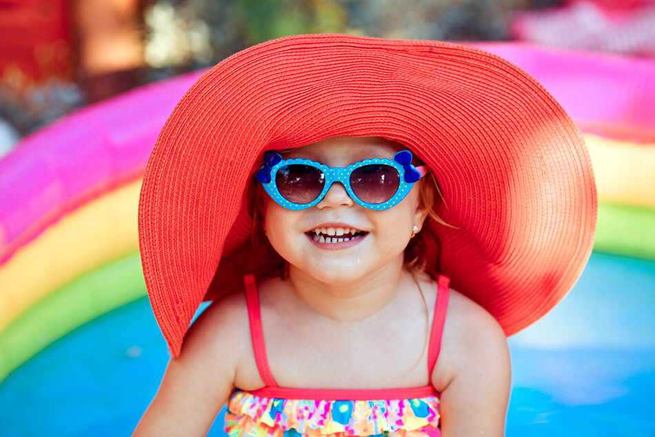 small girl wearing sunglasses as eye protection