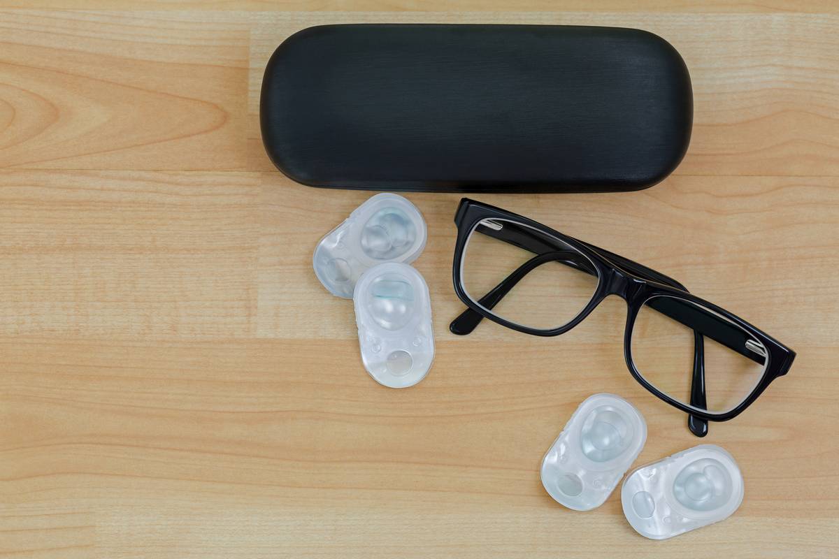 glasses case, glasses and disposable contacts on table