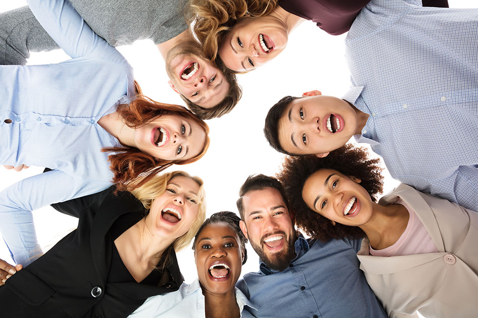 Group of happy college students huddled together