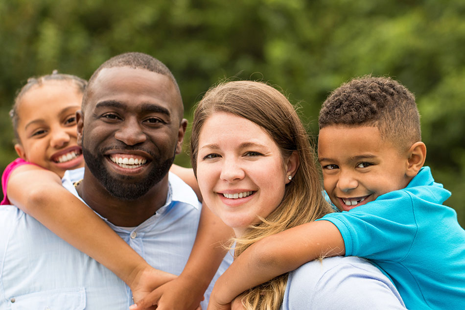 Husband and wife with children on their backs