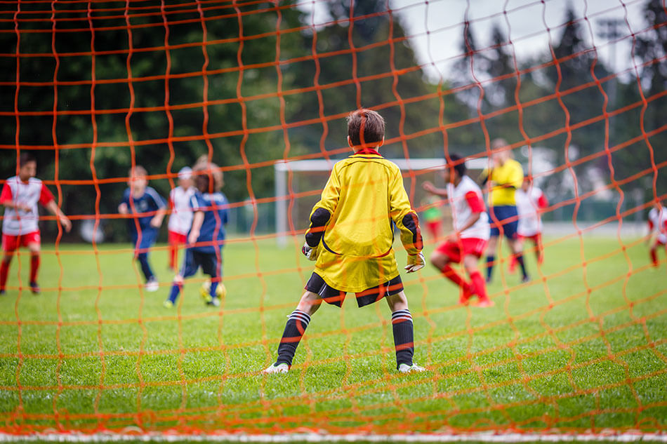 kids playing soccer on the field