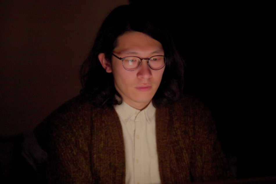 Man using a computer at night experiencing eye strain from screen light