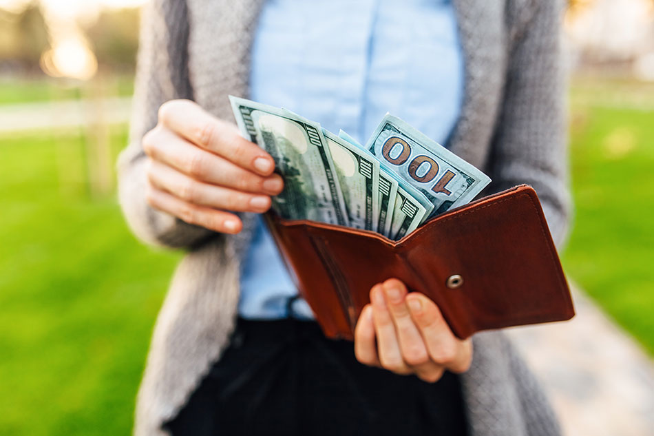 man pulling money of out wallet