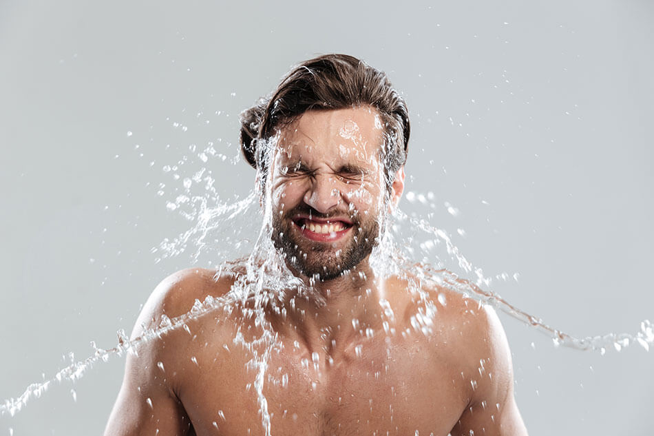 Man getting splashed in the face with water