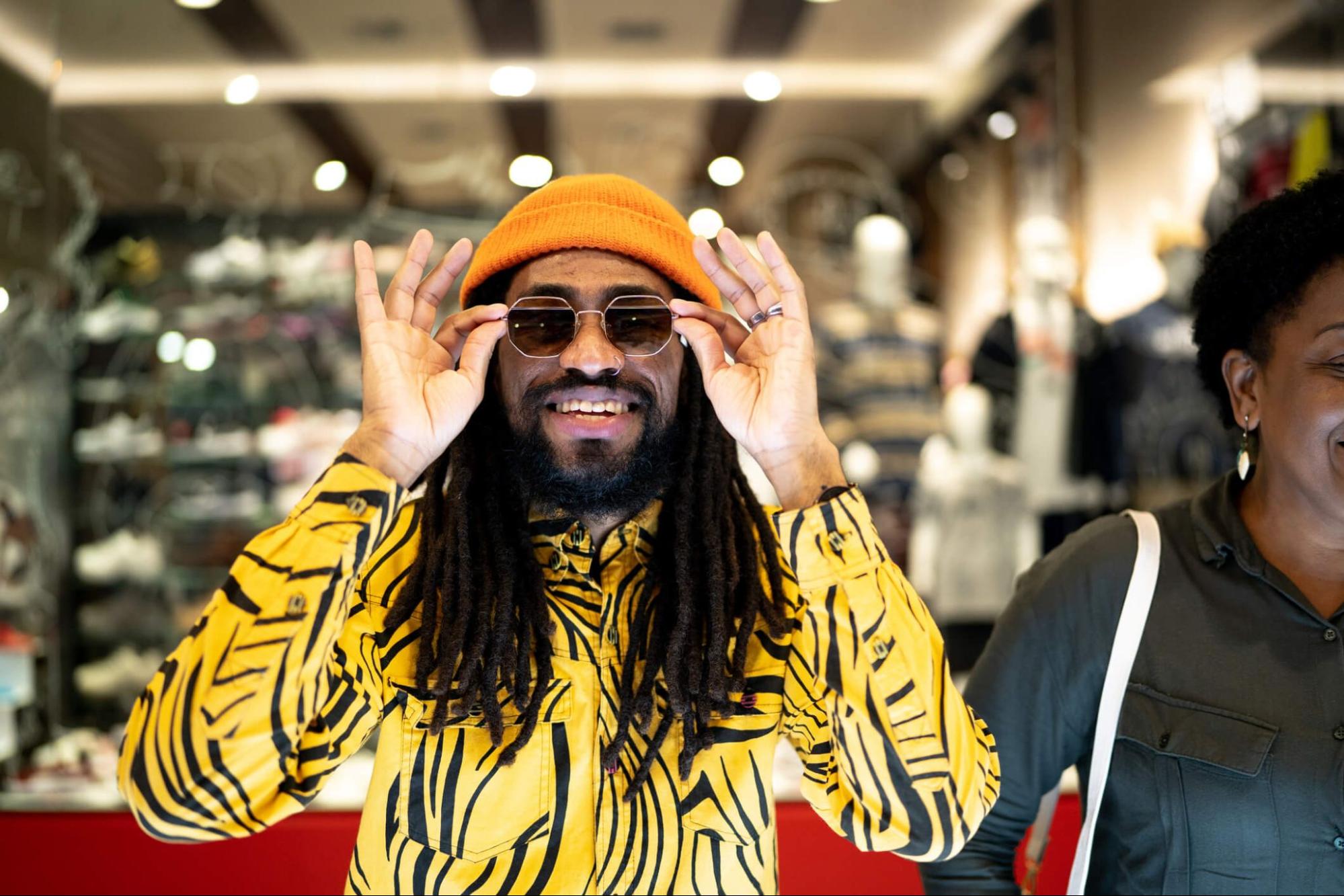 A man trying on UV protection sunglasses in retail store