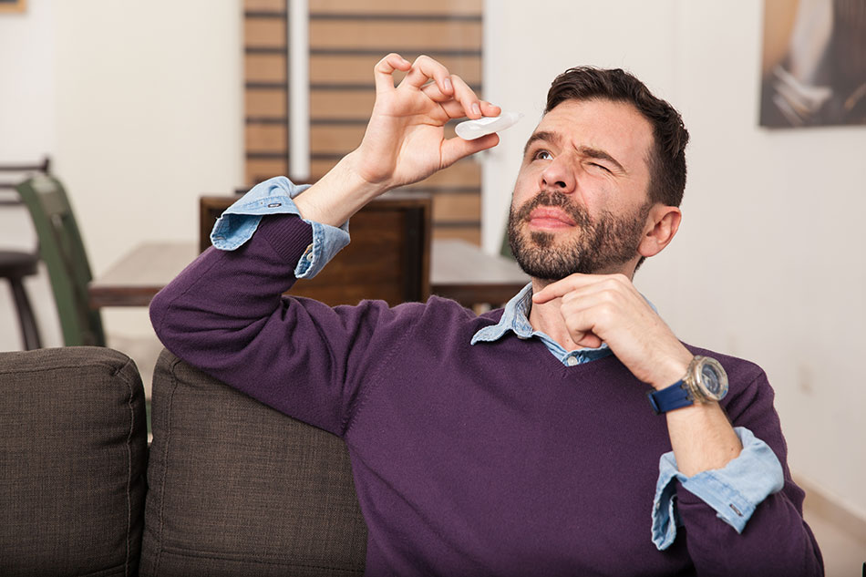 Man using eye drops for contact lost in eye