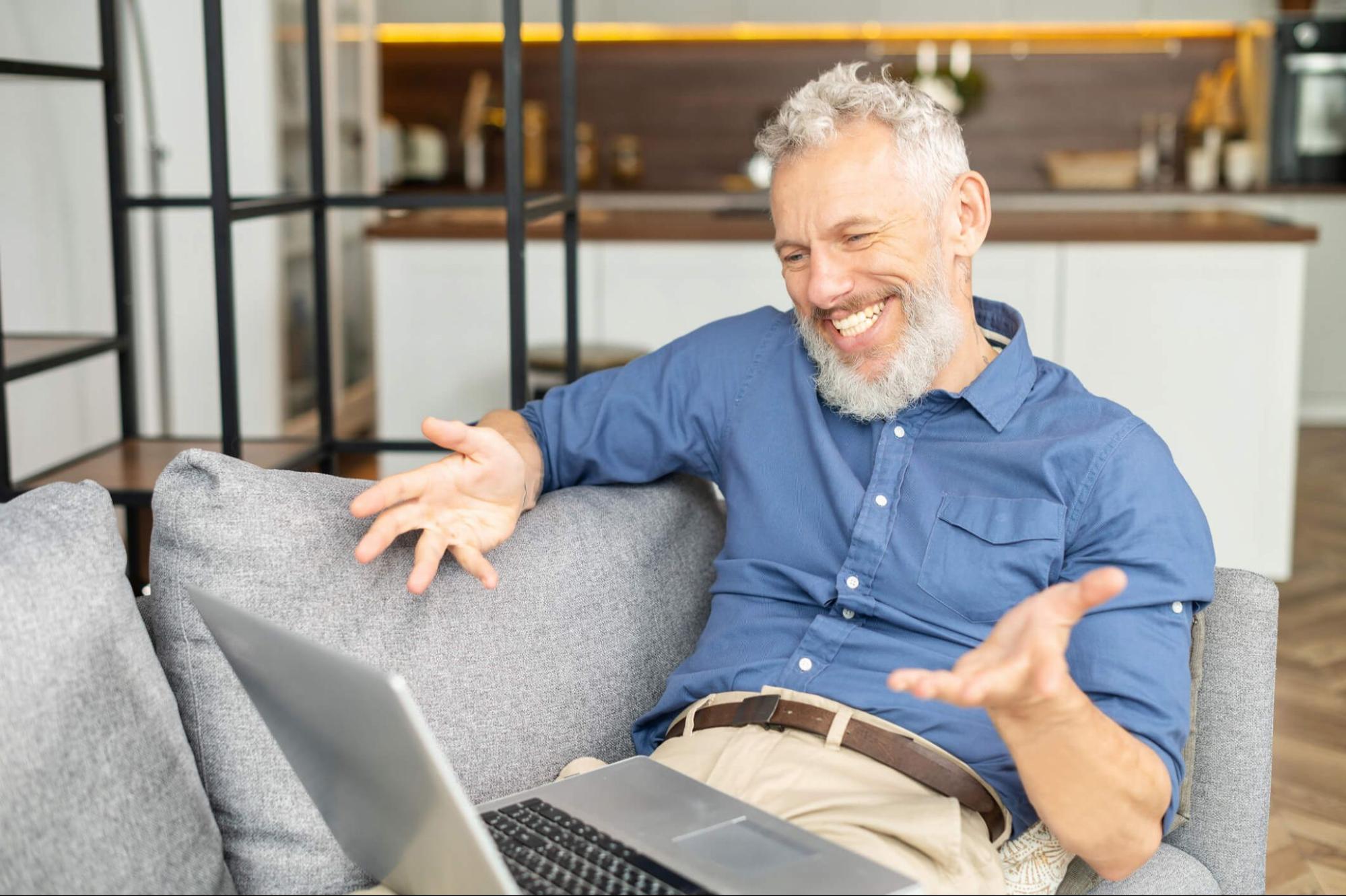 Mature man comfortably viewing a laptop screen after switching to multifocal contact lenses