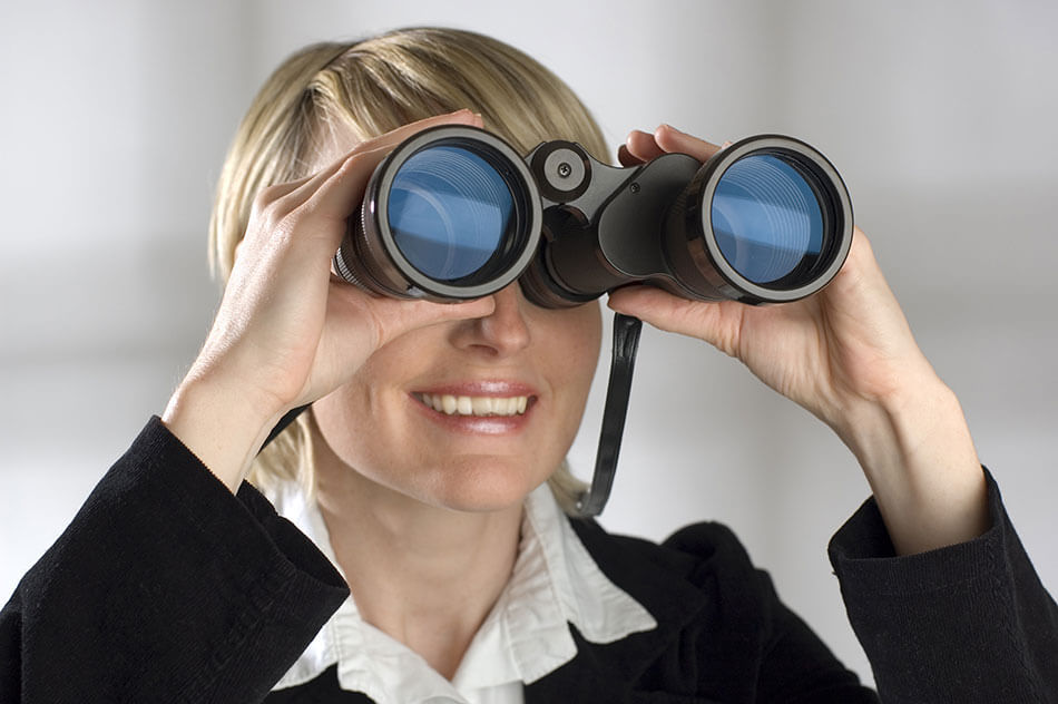 Middle aged woman looking through binoculars