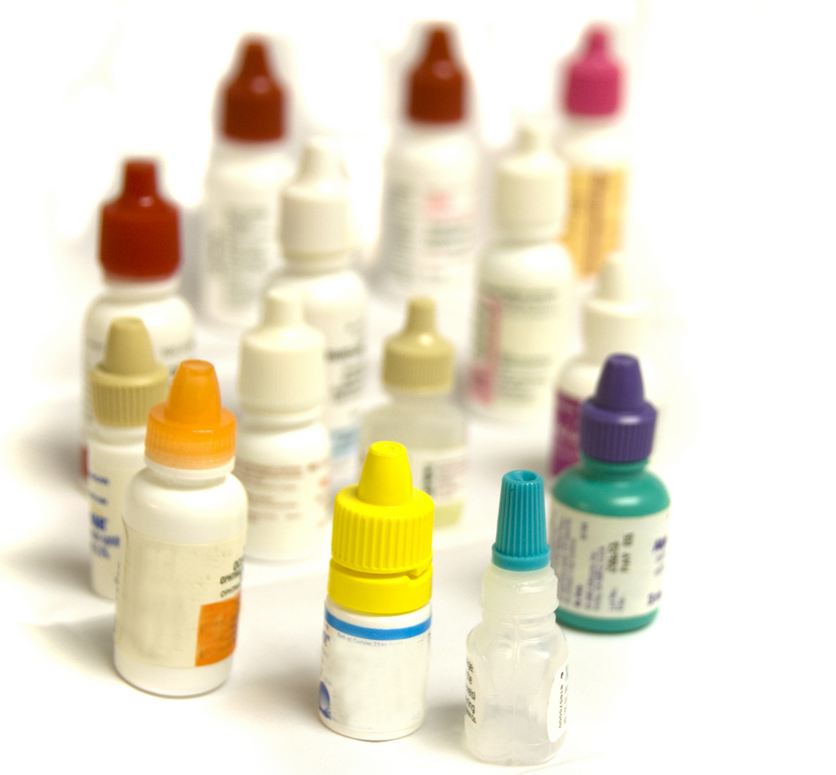 different colored bottles of eye drops