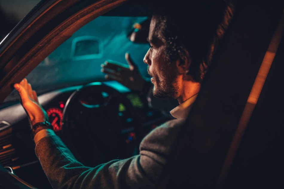 Driver struggling with visibility while driving at night inside a car