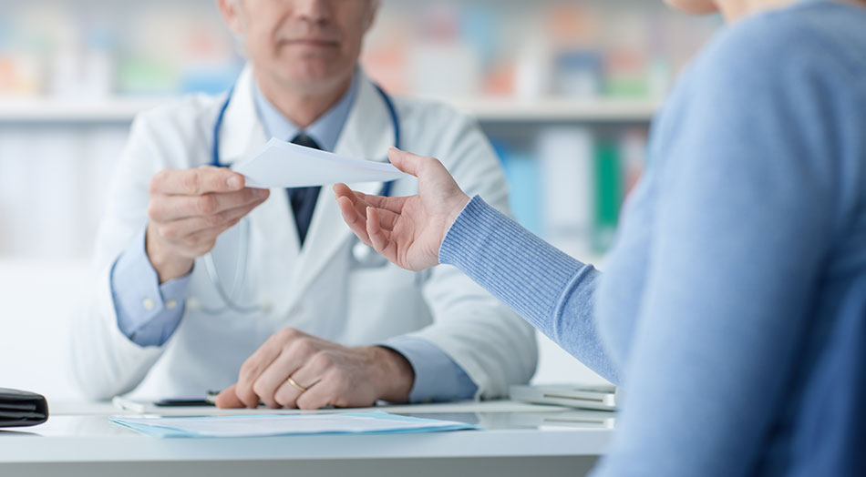 patient collecting prescription from doctor