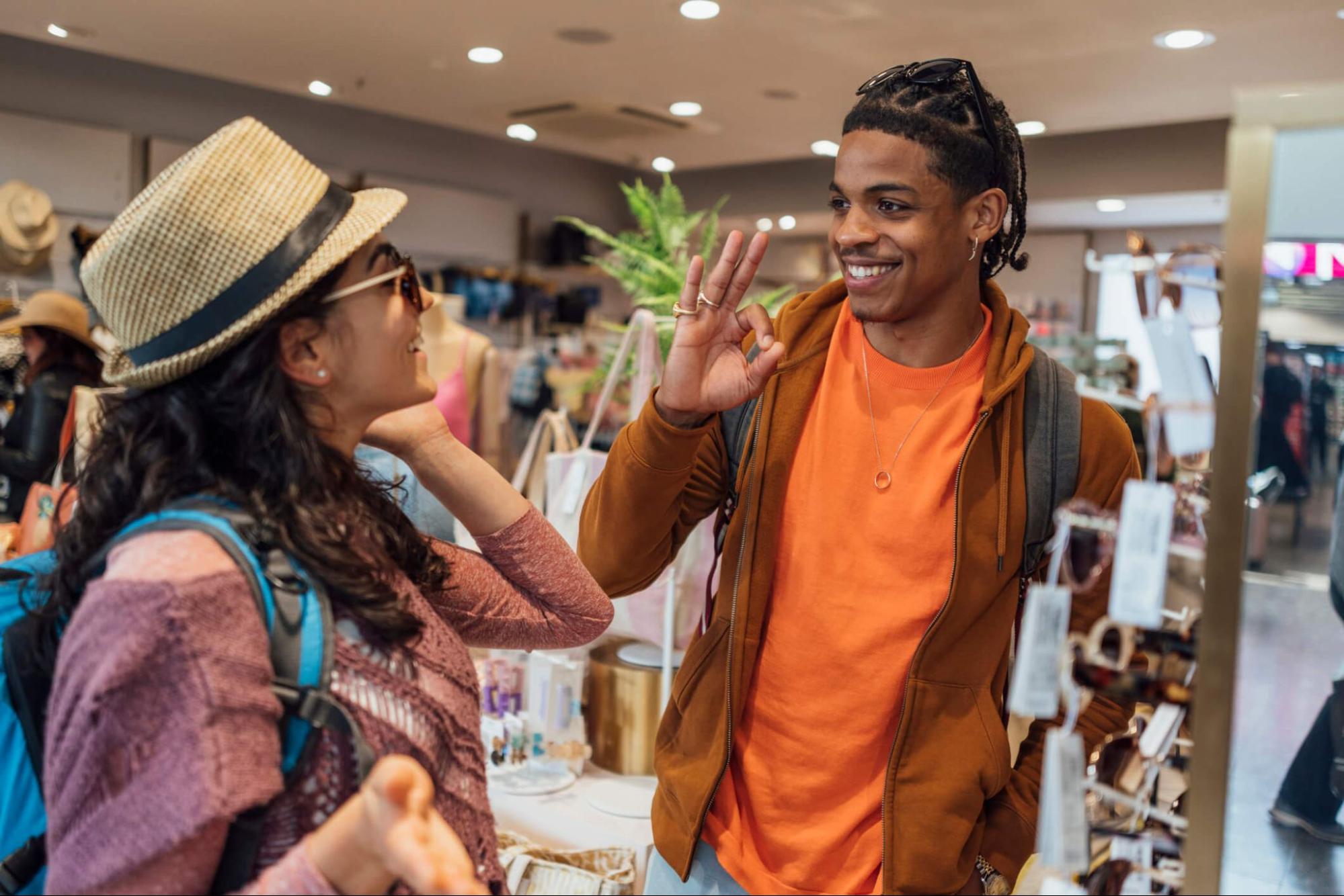 Shoppers comparing sunglasses for UV protection in retail store