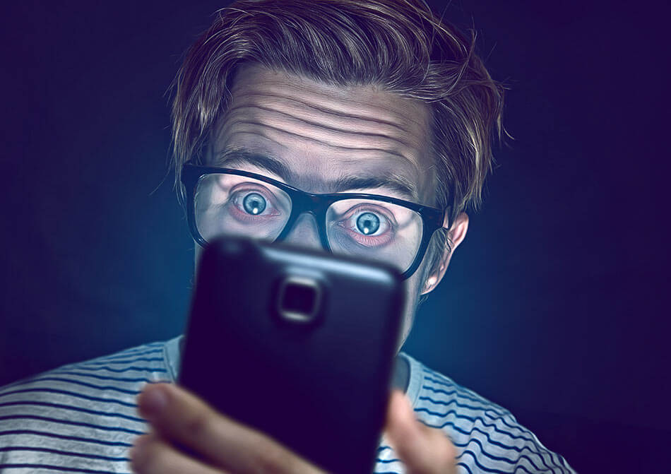 man staring into smartphone