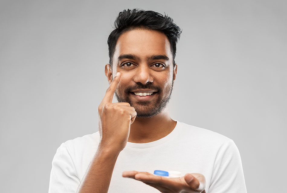 smiling man with contact lens case