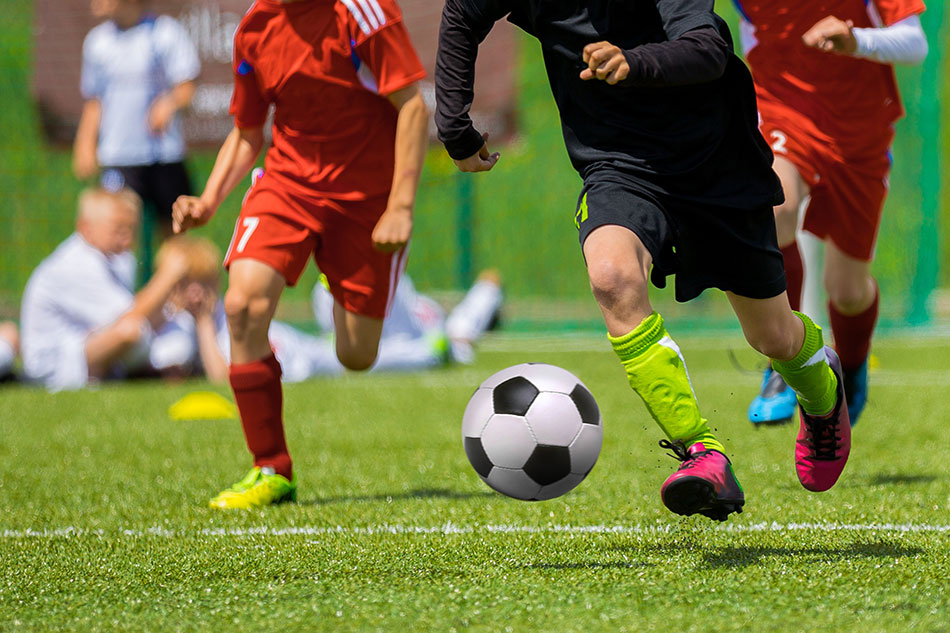 action shot of 3 soccer players in motion