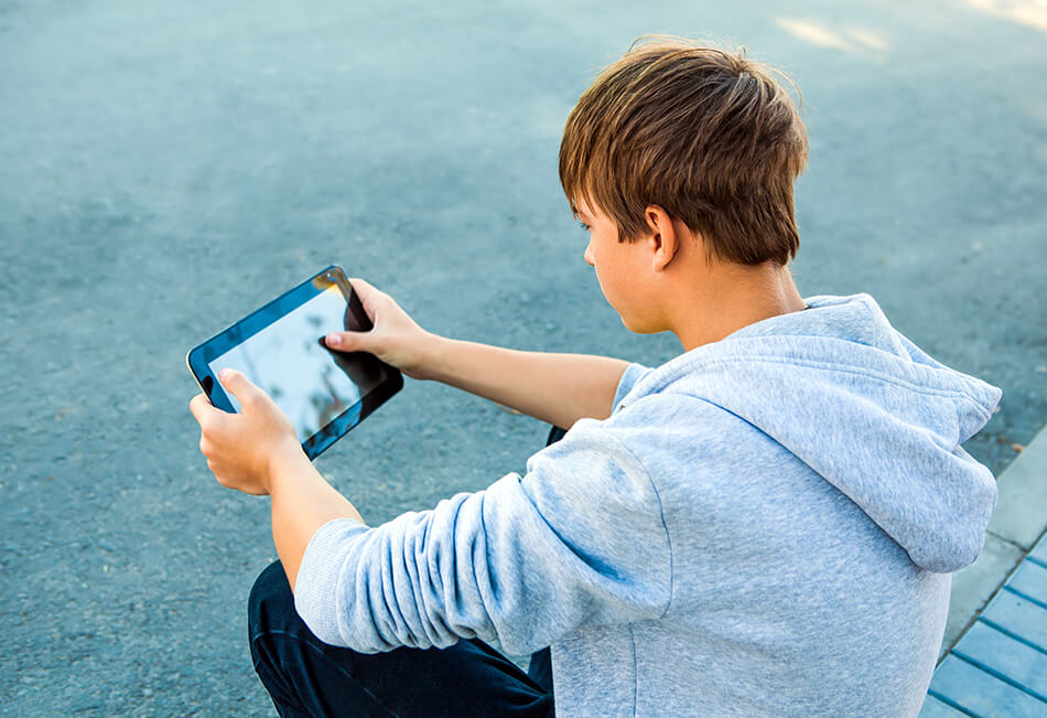 Teen boy using tablet