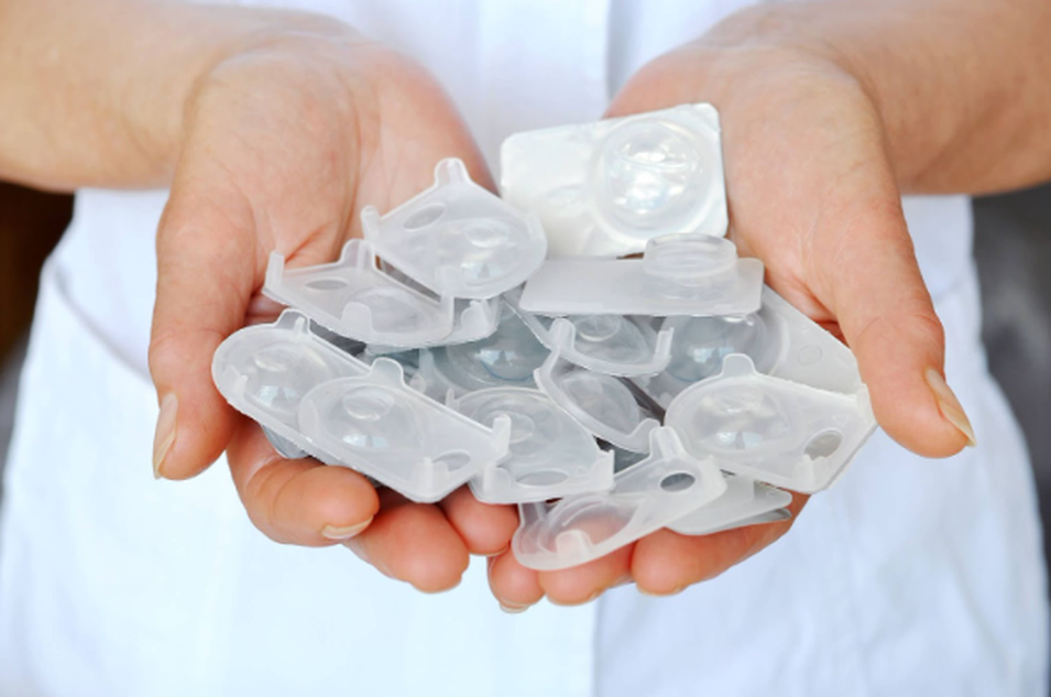 uhands holding used contact lens blister packs
