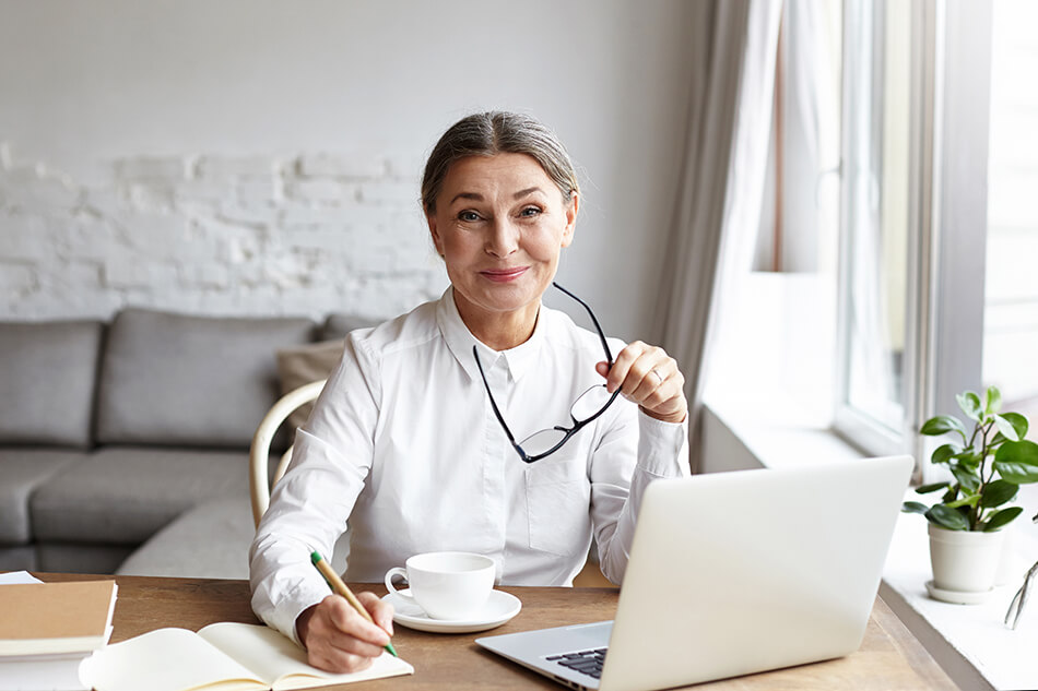 Woman sitting at desk with laptop in front of her