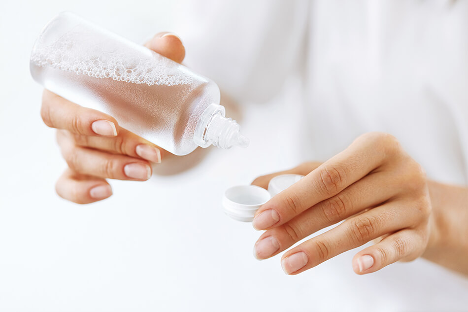 woman with contact lenses and cleaning solution