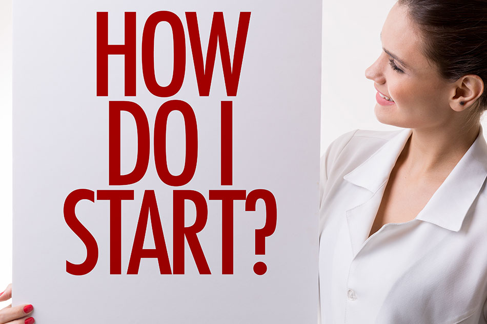 Woman holding sign saying “How do I start?”