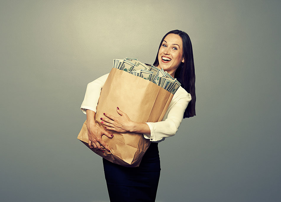 Woman hugging large paper bag full of money