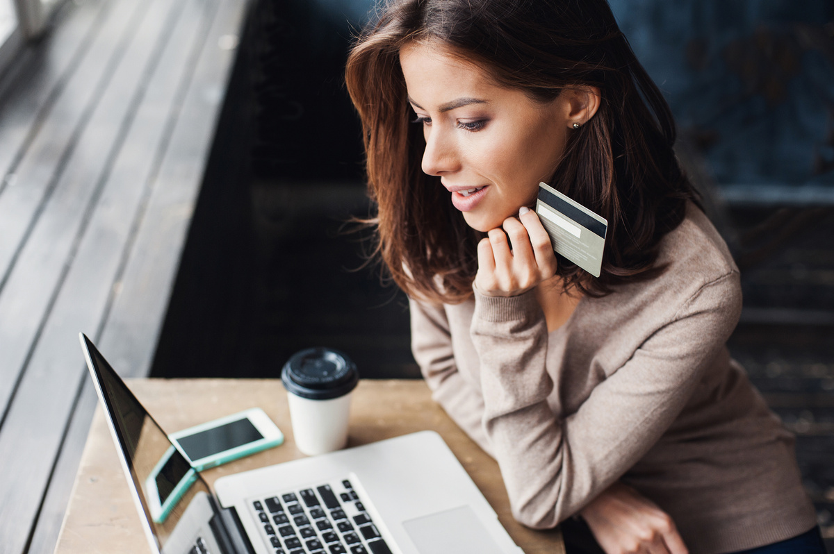 woman with laptop and credit card shopping online