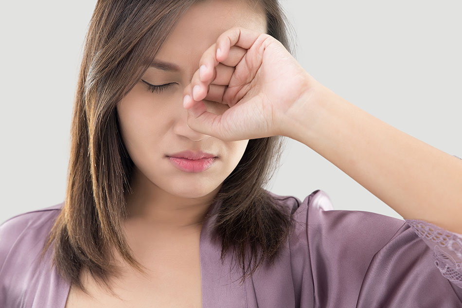 Woman rubbing sore eyes