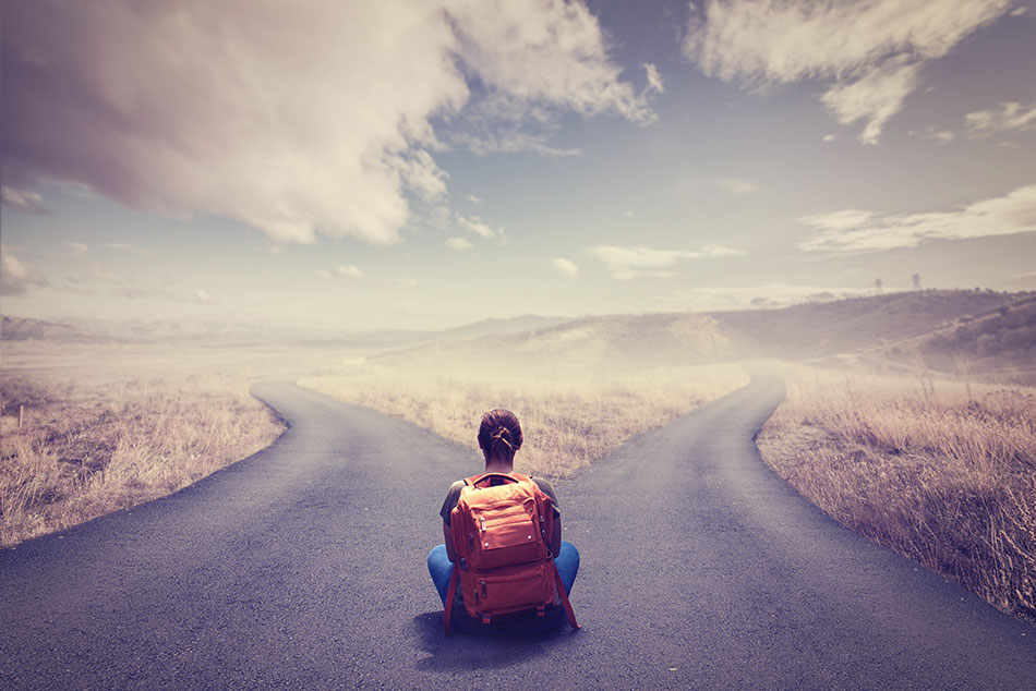 woman sitting at crossroads