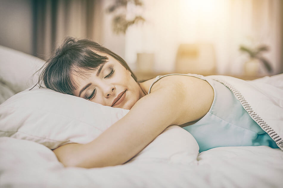 woman sleeping on stomach resting head on pillow